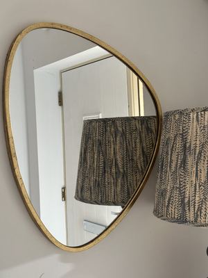 Statement mirror hung in a hallway